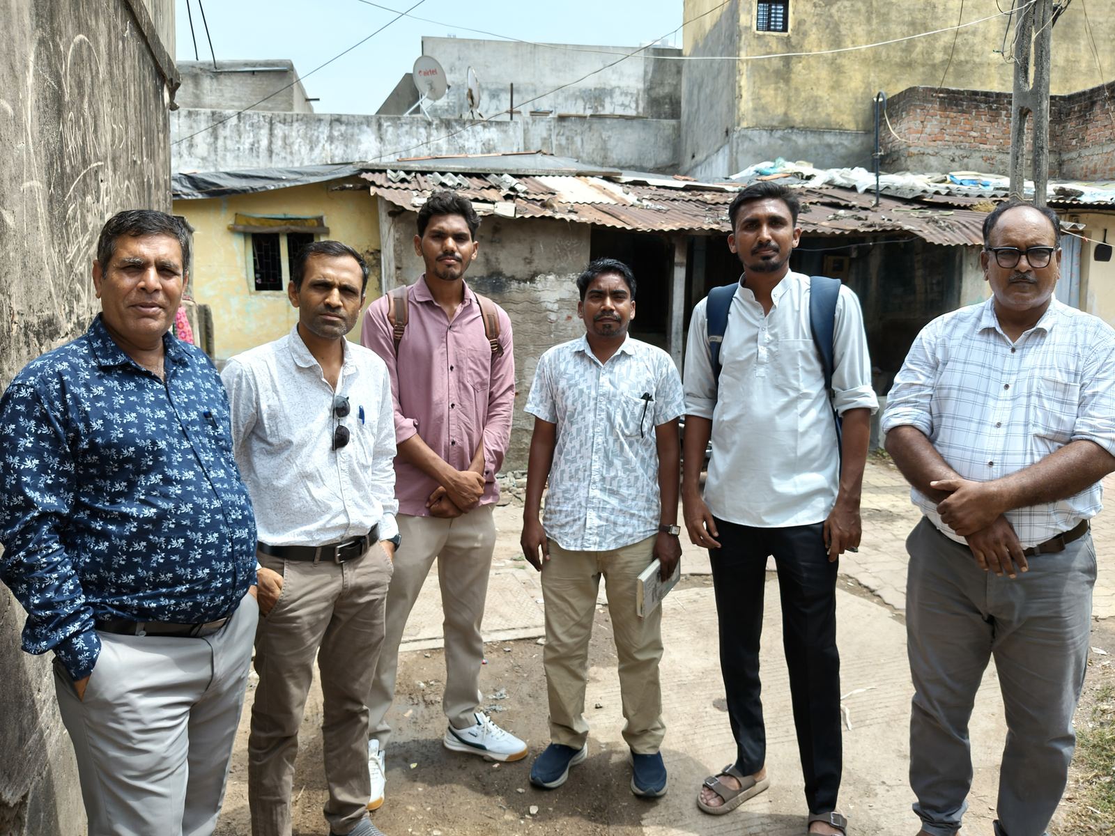 The Manav Garima team standing together in a basti in Ahmedabad