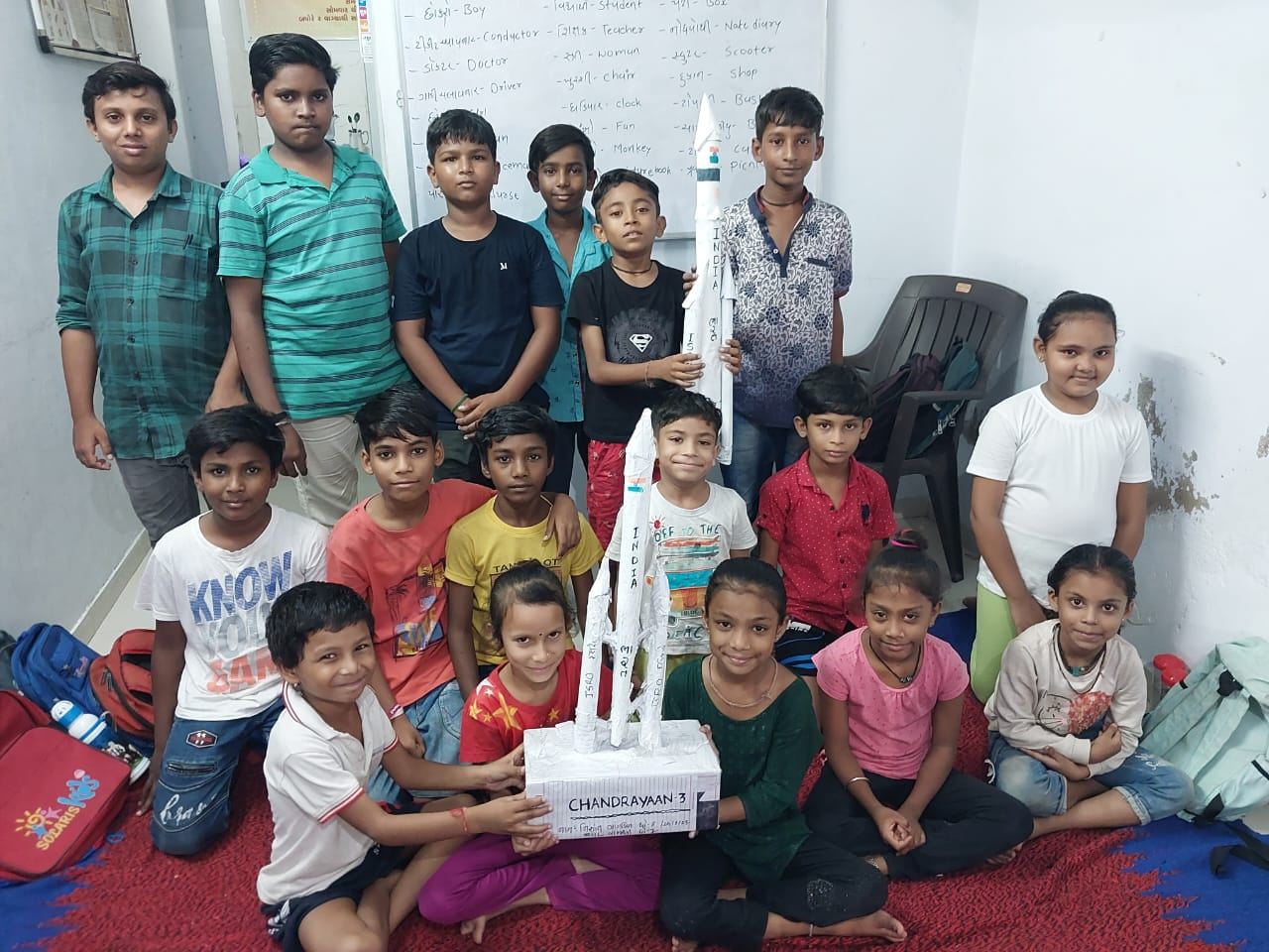 Children holding a model rocket they made