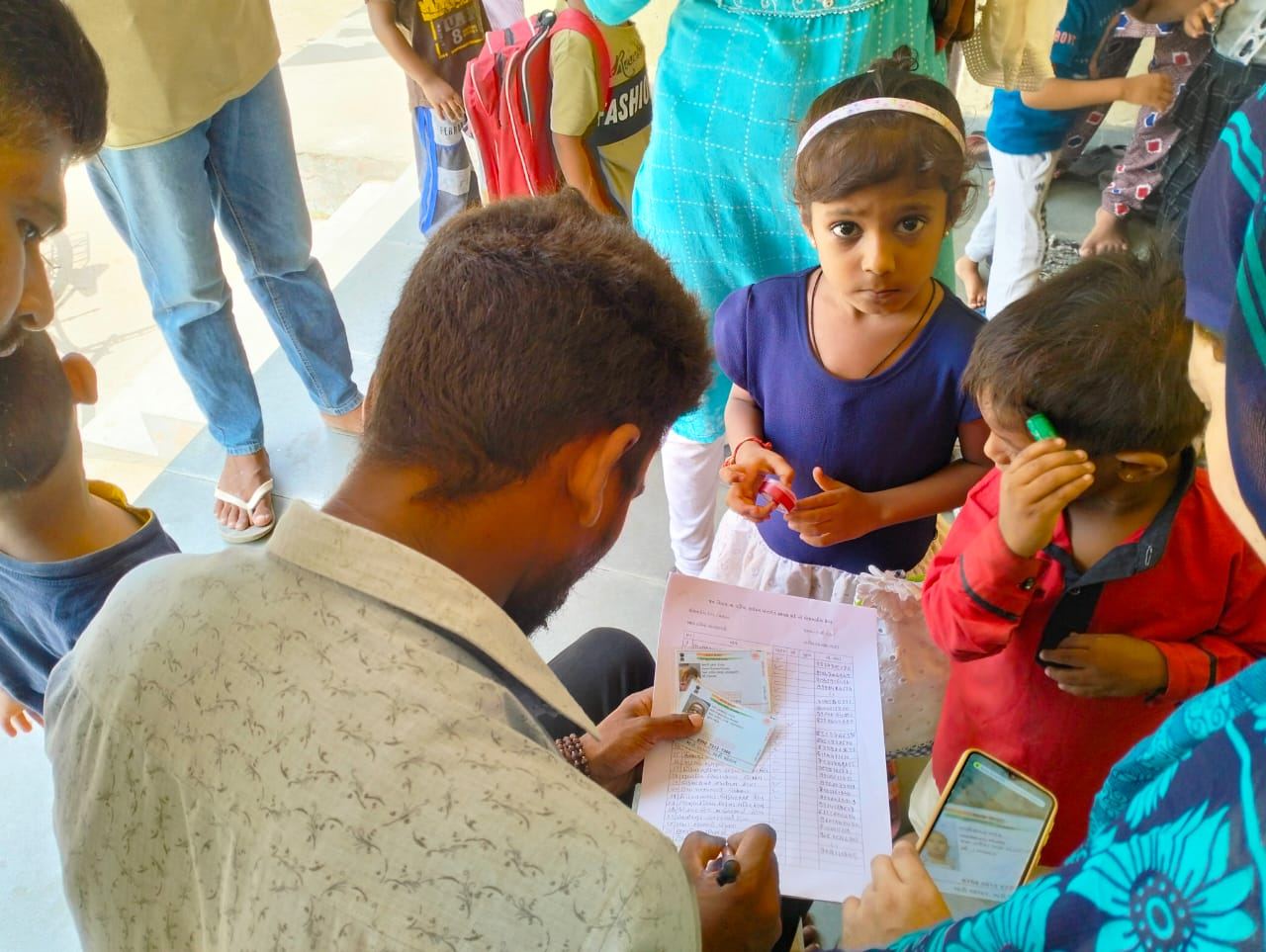 A team member filling a form with a family