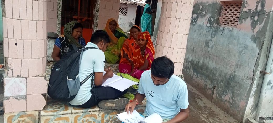 Team members helping women fill documents