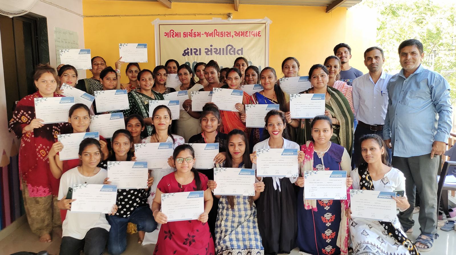 Young women holding training certificates