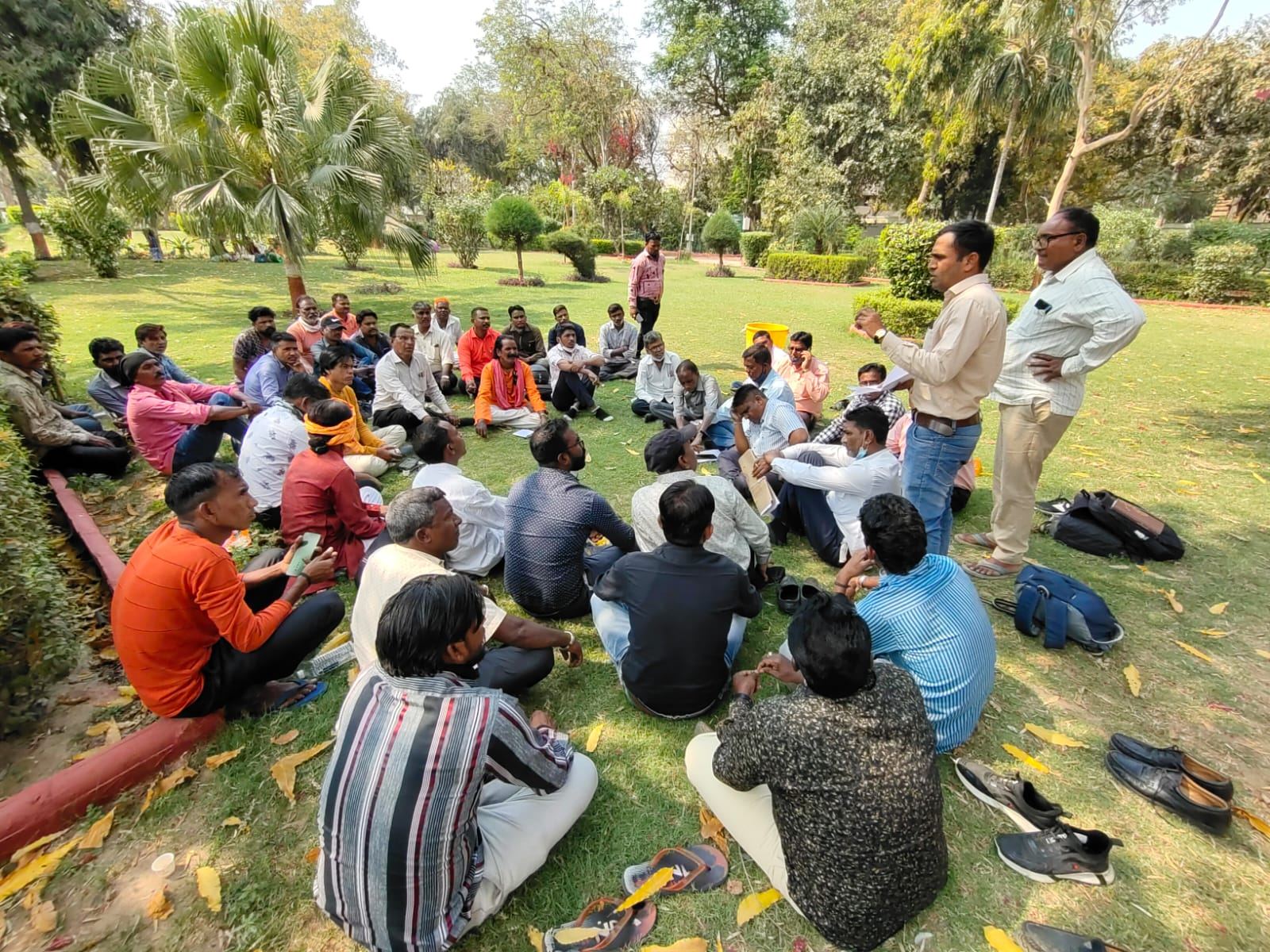 Sanitation workers at a meeting in a park